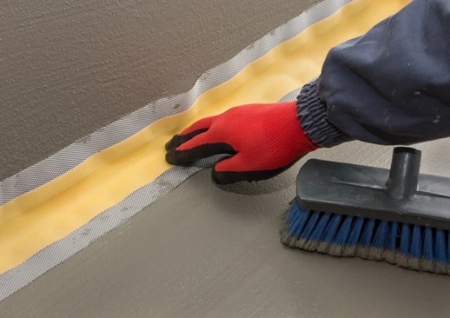 Waterproofing the corner- red glove